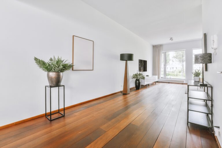 Interior of living room with comfortable sofa and TV against windows in contemporary apartment
